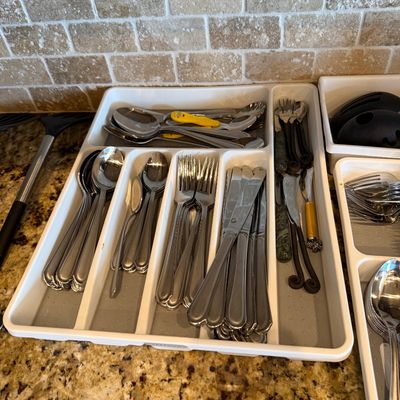Sale Photo Thumbnail #174: Plastic drawer organizer filled with stainless steel flatware and various kitchen utensils.