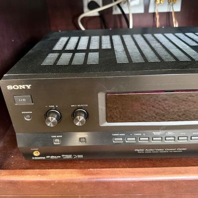 Sale Photo Thumbnail #223: Black Sony Digital Audio/Video Control Center receiver sitting on a wooden media shelf.