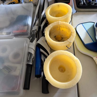 Sale Photo Thumbnail #86: Collection of household items including yellow candle lanterns with wire handles, full-length umbrellas, clear plastic storage bins, hand tools, and pickleball paddles.