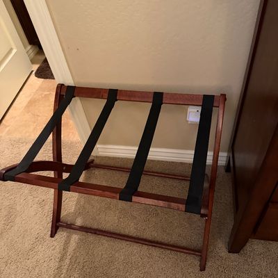 Sale Photo Thumbnail #146: Folding wooden luggage rack with four black fabric straps in a rich reddish-brown stain finish.