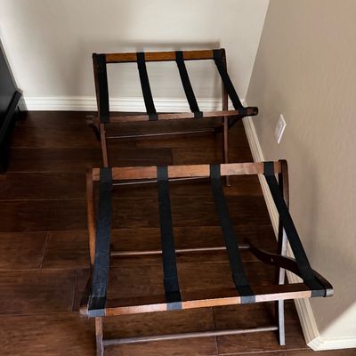 Sale Photo Thumbnail #22: Pair of folding wooden luggage racks with black webbing straps, in good condition.