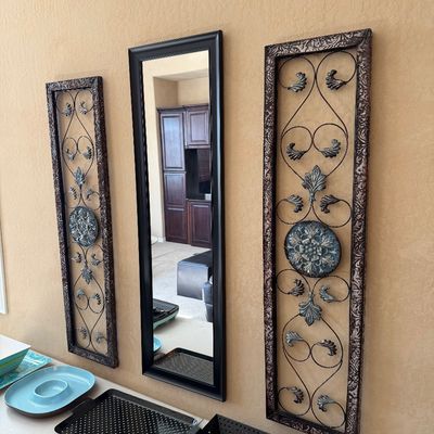 Sale Photo Thumbnail #198: Three-piece wall decor set including a tall rectangular mirror flanked by matching ornamental wrought iron panels with ornate wooden frames.