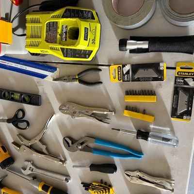 Sale Photo Thumbnail #82: Assorted hand tools and hardware accessories including locking pliers, screwdrivers, a Ryobi battery charger, and Stanley utility blades.