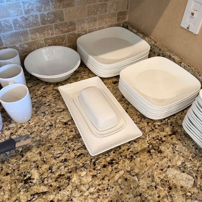 Sale Photo Thumbnail #181: Set of modern white porcelain dinnerware including square plates, bowls, mugs, and a covered butter dish.