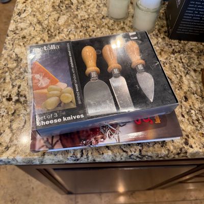 Sale Photo Thumbnail #171: Metalla three-piece cheese knife set, in original packaging with polished wood handles and stainless steel blades.