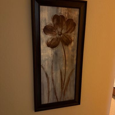 Sale Photo Thumbnail #137: Framed contemporary floral canvas wall art featuring a dark brown stylized flower on a textured blue and gold background.