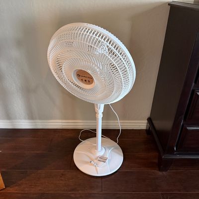 Sale Photo Thumbnail #23: Comfort Zone white plastic oscillating pedestal fan on an adjustable stand.