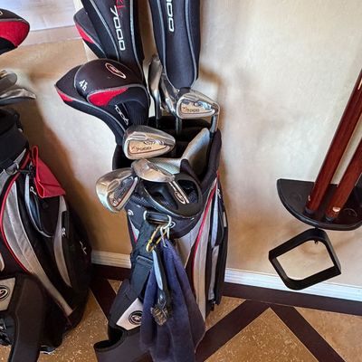 Sale Photo Thumbnail #258: Golden Bear XL7000 complete golf club set housed in a black, grey, and red stand bag, including woods with matching headcovers, irons, and a putter.