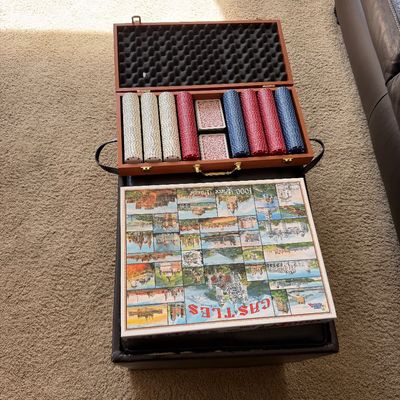 Sale Photo Thumbnail #56: Open wooden poker chip set case with chips and playing cards, paired with a sealed 1000-piece "Castles of Europe" jigsaw puzzle.