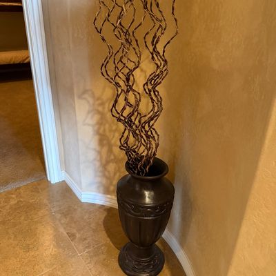 Sale Photo Thumbnail #67: Tall dark bronze-tone ceramic urn floor vase featuring decorative relief carving, filled with dried curly willow branches.