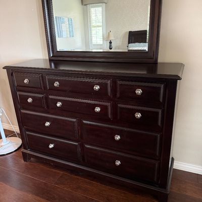 Sale Photo Thumbnail #24: Dark mahogany-finish double dresser featuring nine drawers with clear faceted knobs and a matching arched attachment mirror.