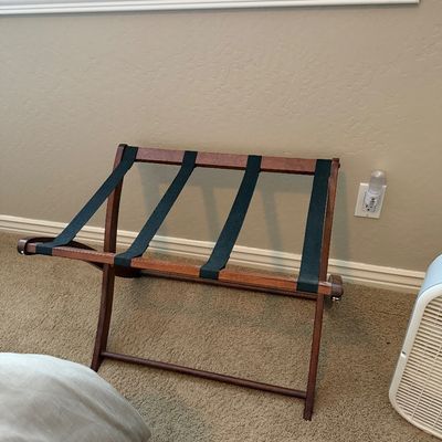 Sale Photo Thumbnail #111: Wooden folding luggage rack featuring four black woven straps and a reddish-brown finish.
