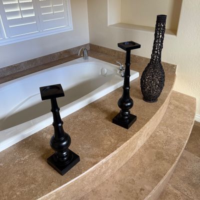 Sale Photo Thumbnail #15: Pair of tall contemporary black painted wooden pillar candle holders and a dark woven openwork decorative vase, arranged on a stone bathtub ledge.