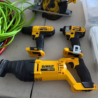 Sale Photo Thumbnail #89: Set of modern DeWalt 20V MAX cordless power tools, including a reciprocating saw, impact driver, drill, and 6 1/2-inch circular saw.