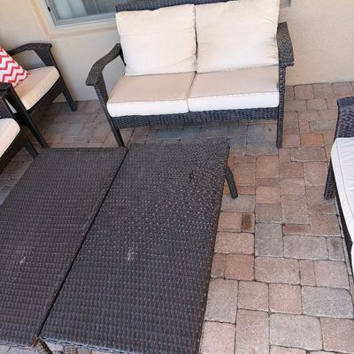 Sale Photo Thumbnail #245: Modern outdoor patio furniture set featuring dark brown resin wicker love seat, matching chairs, and a coffee table with off-white cushions.