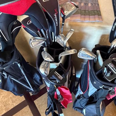 Sale Photo Thumbnail #252: Set of Top-Flite XL7000 golf clubs with matching headcovers in a black carry bag alongside additional golf bags.