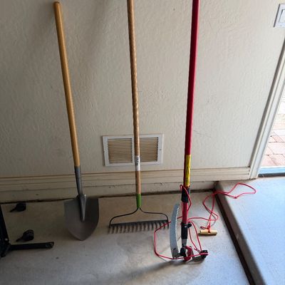 Sale Photo Thumbnail #73: Set of long-handled yard tools including a shovel, garden rake, and pole saw with pruner attachment.