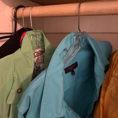 Sale Photo Thumbnail #121: Selection of women's Talbots jackets in bright green and turquoise hanging in a closet.