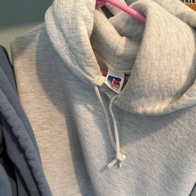 Sale Photo Thumbnail #97: Vintage light gray Russell Athletic hooded sweatshirt, size XL, featuring drawstring hood and classic logo tag.