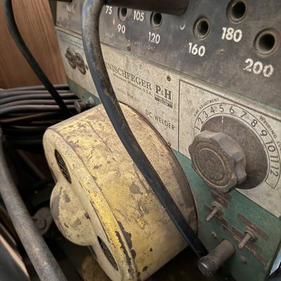 Sale Photo Thumbnail #159: Vintage Harnischfeger P&H Model WNP-200 DC welder featuring a heavy-duty industrial control panel and weathered yellow casing.