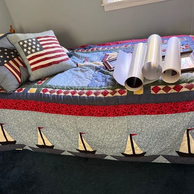 Sale Photo Thumbnail #115: Nautical-themed patchwork quilt featuring sailboat motifs along the border, displayed on a bed with patriotic flag and star throw pillows.