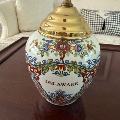 Sale Photo Thumbnail #79: Vintage ceramic tobacco jar or ginger jar labeled 'DELAWARE' with colorful floral designs and a metallic gold-toned brass lid.
