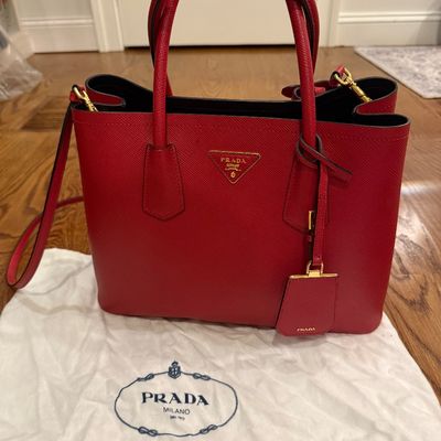 Sale Photo Thumbnail #11: Red Prada Saffiano leather tote bag with gold-tone hardware, shoulder strap, attached key fob, and original dust bag.