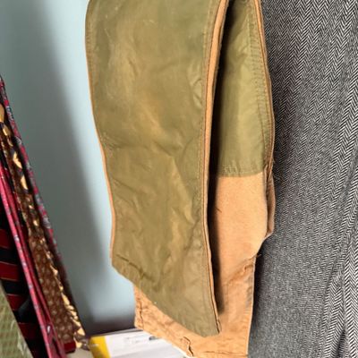 Sale Photo Thumbnail #85: Vintage olive green and tan canvas hunting pants folded over a pink hanger.