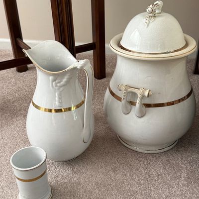Sale Photo Thumbnail #35: Vintage white ceramic wash basin set including a pitcher, covered urn, and small tumbler with gold band accents.
