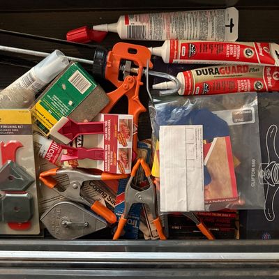 Sale Photo Thumbnail #144: Toolbox drawer filled with caulking tools, sealant tubes, spring clamps, chalk reel, and a boxed Clifton 550 concave spokeshave.