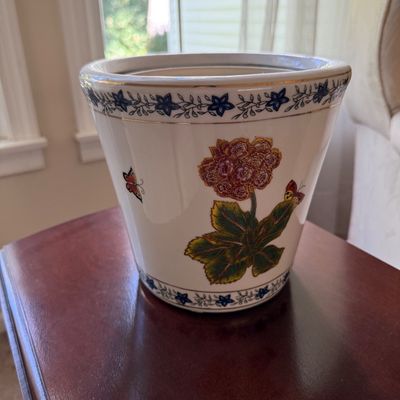 Sale Photo Thumbnail #31: White ceramic planter pot featuring hand-painted floral, butterfly, and gold trim accents.