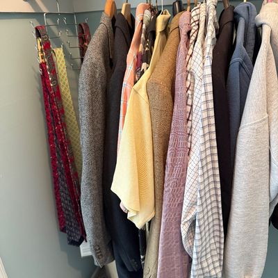 Sale Photo Thumbnail #100: Closet full of vintage men's clothing, including suit jackets, button-down shirts, hoodies, and hanging neckties.