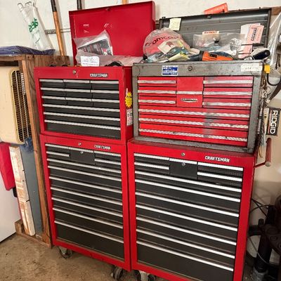 Sale Photo Thumbnail #63: Two sets of vintage red Craftsman rolling tool chest stacks with multi-drawer top boxes and bottom cabinets, showing moderate wear.