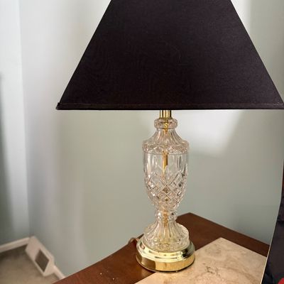 Sale Photo Thumbnail #18: Traditional cut crystal table lamp featuring brass accents and a black pyramid lampshade.