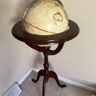 Sale Photo Thumbnail #51: Replogle 12-inch World Classic floor-standing globe set in a dark wood tripod stand with full metal meridian ring.