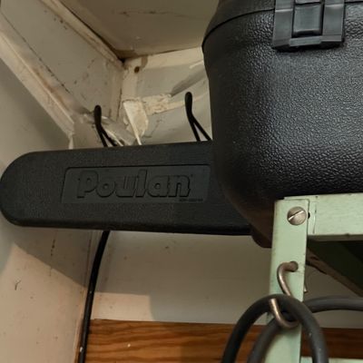 Sale Photo Thumbnail #161: Poulan chainsaw stored inside its textured black plastic carrying case