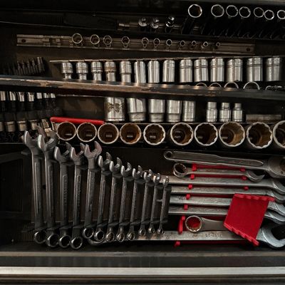 Sale Photo Thumbnail #152: Toolbox drawer filled with organized hand tools, including metric combination wrenches, various socket sets on rails, and ratchets.