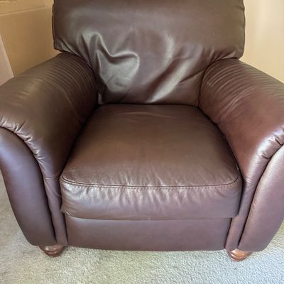 Sale Photo Thumbnail #46: Contemporary dark brown leather armchair featuring thick rolled arms and bun feet in good condition.