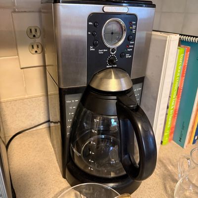 Sale Photo Thumbnail #56: Mr. Coffee 12-cup programmable coffee maker in stainless steel and black finish, complete with glass carafe.