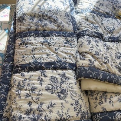 Sale Photo Thumbnail #114: Blue and white floral toile patchwork comforter featuring intricate botanical patterns and dark blue borders.