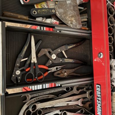 Sale Photo Thumbnail #137: Open drawers of a red Craftsman tool chest filled with assorted hand tools, including scrapers, Robo Grip pliers, scissors, and various open-end and combination wrenches.