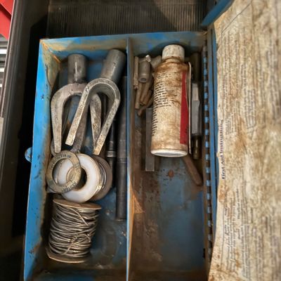 Sale Photo Thumbnail #153: Vintage blue metal utility kit box containing rolls of Kester solder, various metal components, and a small chemical bottle.