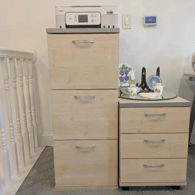 Pair of light wood finish office file cabinets, including a three-drawer tall vertical cabinet and a matching three-drawer rolling mobile...
