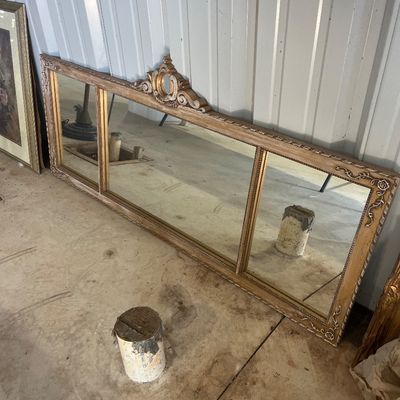 Sale Photo Thumbnail #79: Large vintage French provincial style wide overmantel mirror with an ornate whitewashed and gilt wood frame featuring a central pediment design.