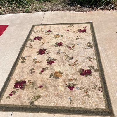 Sale Photo Thumbnail #114: Rectangular area rug featuring a beige background with a floral and fruit pattern in shades of burgundy, yellow, green, and blue, framed by an olive green border.