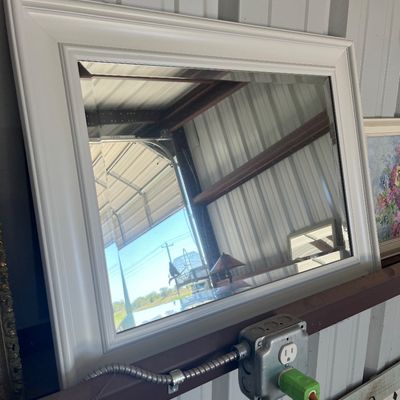 Sale Photo Thumbnail #58: Large rectangular wall mirror with a thick white painted wooden frame and a beveled glass edge.