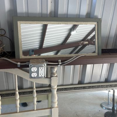 Sale Photo Thumbnail #75: Rectangular wall mirror featuring a painted sage green frame with textured inner trim, displayed alongside a larger ornate silver mirror and a white wooden headboard.