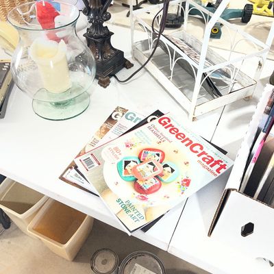Sale Photo Thumbnail #98: Collection of crafting items including GreenCraft magazines, a hurricane candle holder, a decorative lamp base, and paint cans.