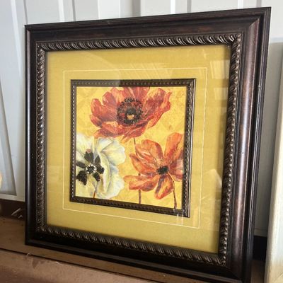 Sale Photo Thumbnail #54: Framed floral print featuring red and white flowers on a mustard yellow background, set in a dark carved wood frame with inner trim detail.