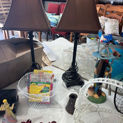 Sale Photo Thumbnail #92: Pair of black metal table lamps with brown fabric lampshades, displayed alongside a variety of household knick-knacks and craft supplies.